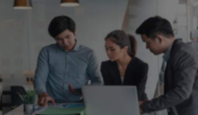 Business people talking with laptop and documents on table