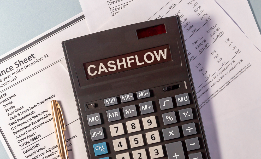 cashflow word on calculator and pen on documents