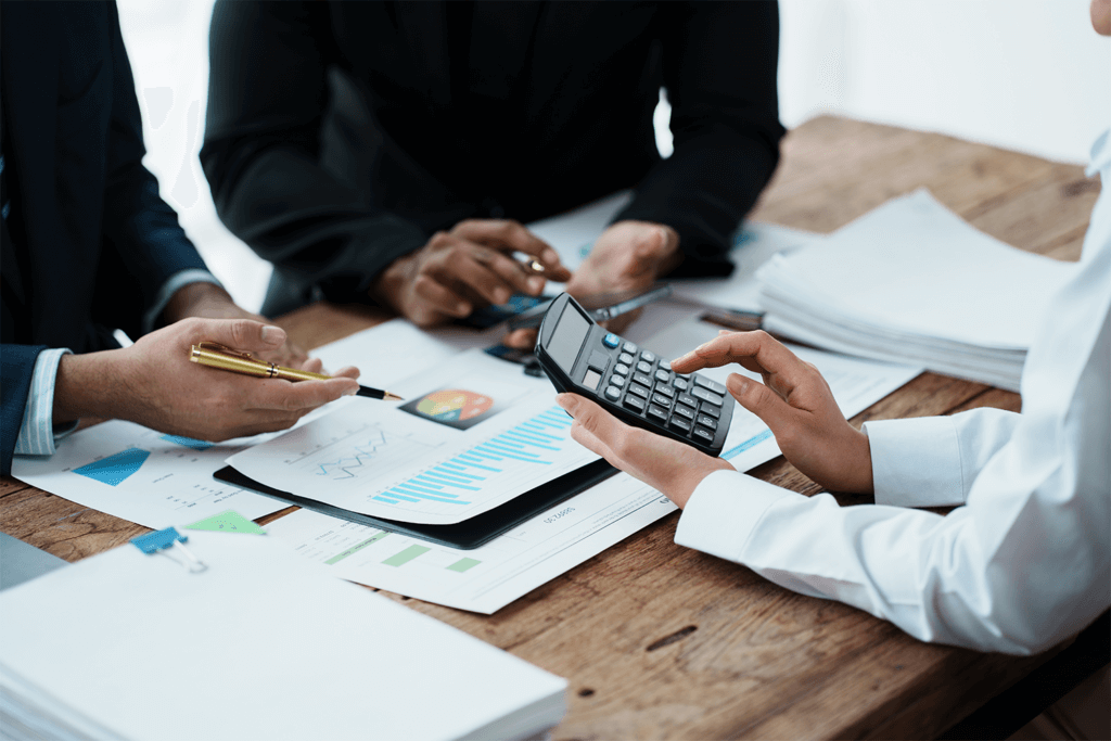 business people calculating funds at meeting